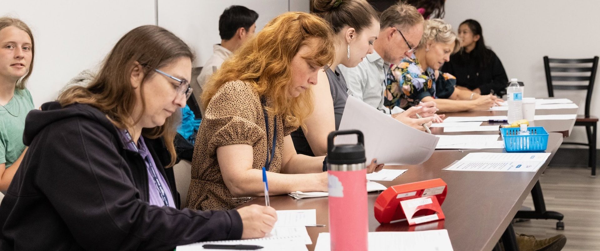 Judges writing ballots at a long table