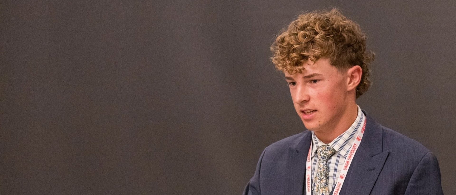 A student speaking at a podium