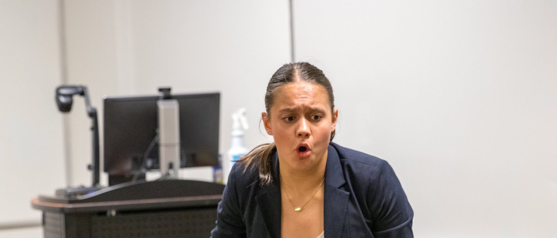 A student gesturing mid-speech