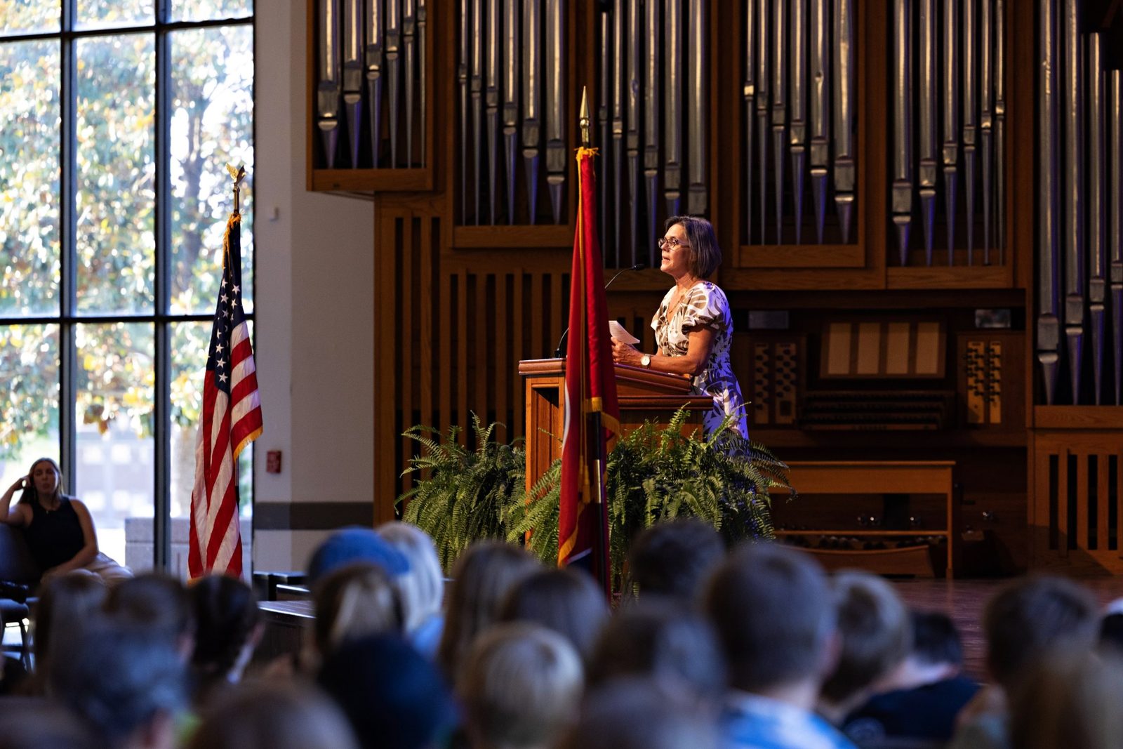 A speaker addressing families gathered in the chapel