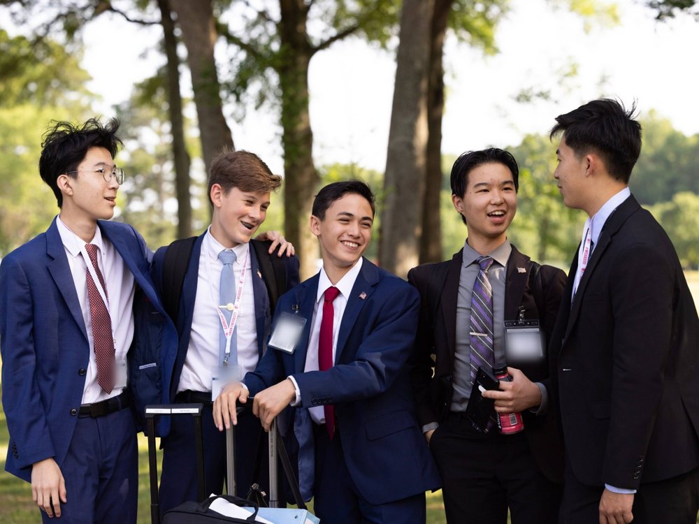Five students laughing together outdoors at NITOC