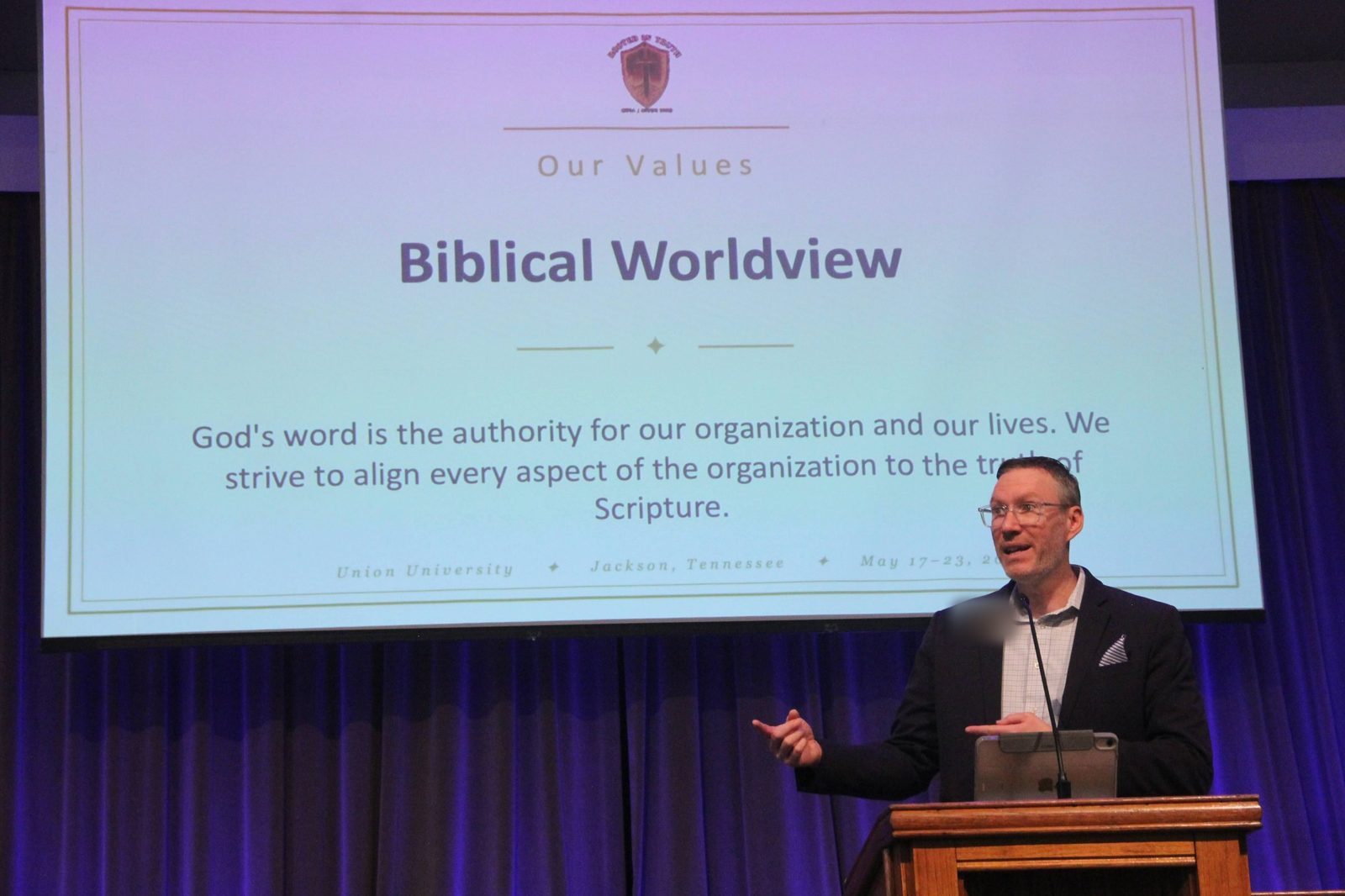 A board member presenting the Biblical Worldview value at the mission, vision, and values reveal